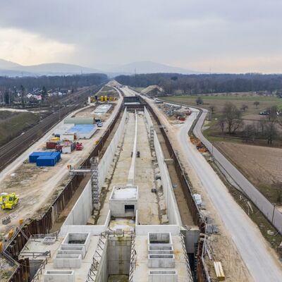 Ein Tunnelportal mit Bauwerken aus Beton.