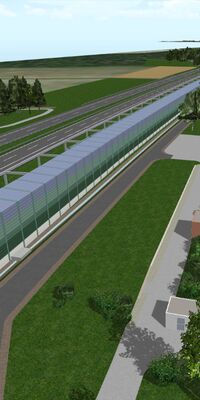 Bahngleise auf der linken Seite sind von Schallschutzwänden vom Wohngebiet getrennt.