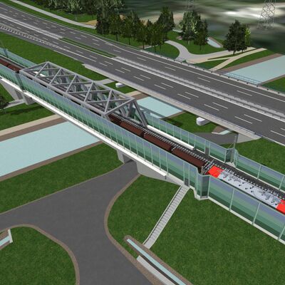 Eine Eisenbahnüberführung über einen Fluss liegt direkt neben einer Autobahnbrücke.