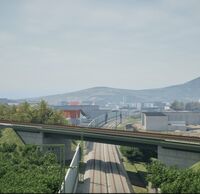 Kurz vor Freiburg führt das Gleis der Höllentalbahn auf einer Brücke über die zwei Gleise der Rheintalbahn.