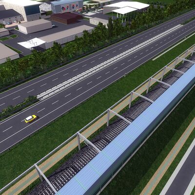 Gleis führt neben einer Autobahn.