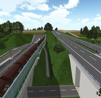 Ein Eisenbahntunnel führt an einer Autobahn entlang.